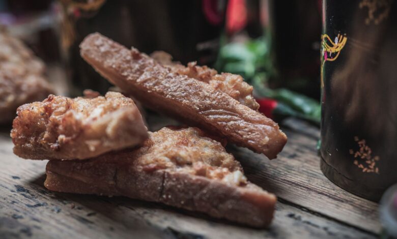 Delicious crispy fried chicken strips on rustic wooden table.