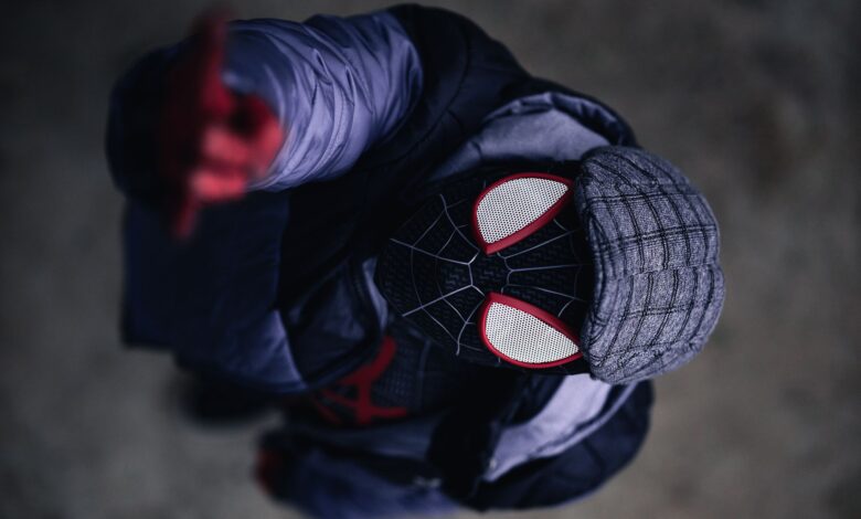 Aerial view of person cosplaying Spider-Man character in detailed costume outdoors.
