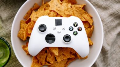 White Xbox controller resting on a bowl of nachos, perfect for gaming snack visuals.