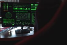 View of a computer monitor displaying green digital security code in an indoor setting.