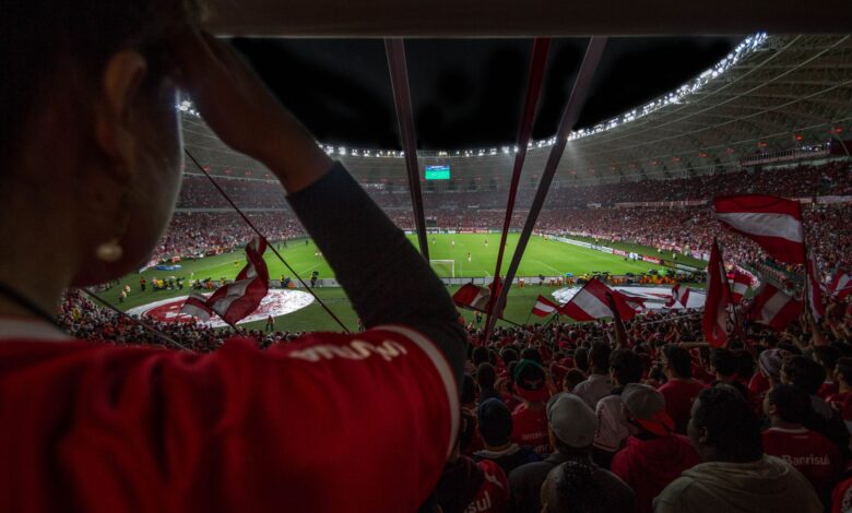 Lively soccer match at packed Brazilian stadium with cheering fans and vibrant atmosphere.