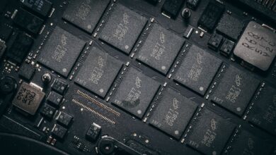 Detailed view of electronic circuit board components showcasing microchips and technology intricacies.