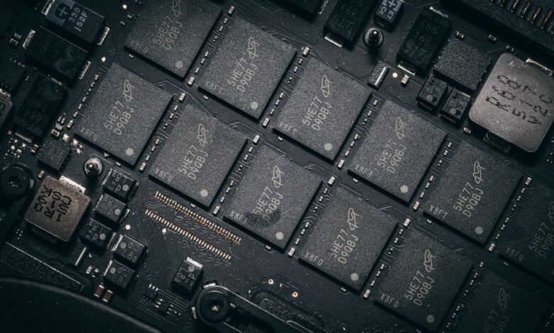 Detailed view of electronic circuit board components showcasing microchips and technology intricacies.