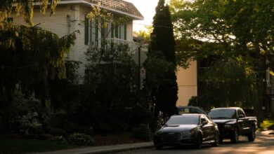 Serene suburban street in Montreal with parked cars and trees at sunset.