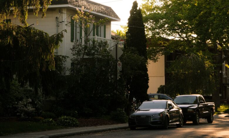 Serene suburban street in Montreal with parked cars and trees at sunset.