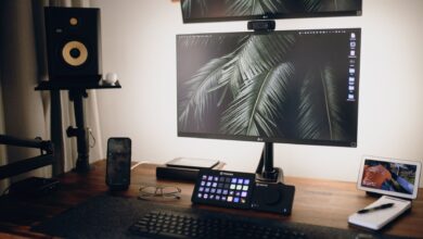 A sleek home office setup featuring dual monitors, tech gadgets, and modern design elements.