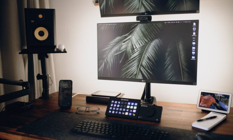 A sleek home office setup featuring dual monitors, tech gadgets, and modern design elements.
