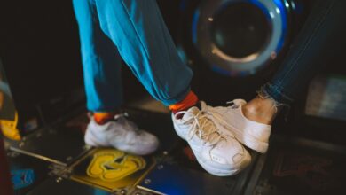 Dynamic close-up of feet playing an arcade dancing game, capturing movement and fun.