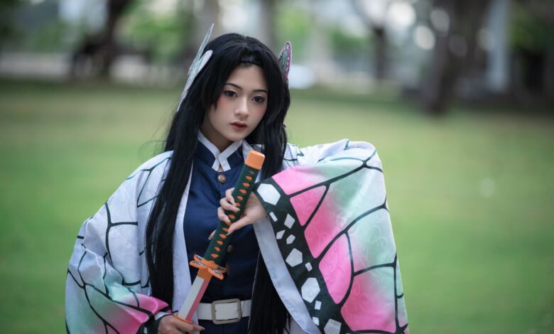 Cosplaying individual dressed as a character from anime, holding a sword in an outdoor setting.