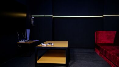 A sleek gaming room featuring controllers and vibrant furniture, ideal for entertainment enthusiasts.