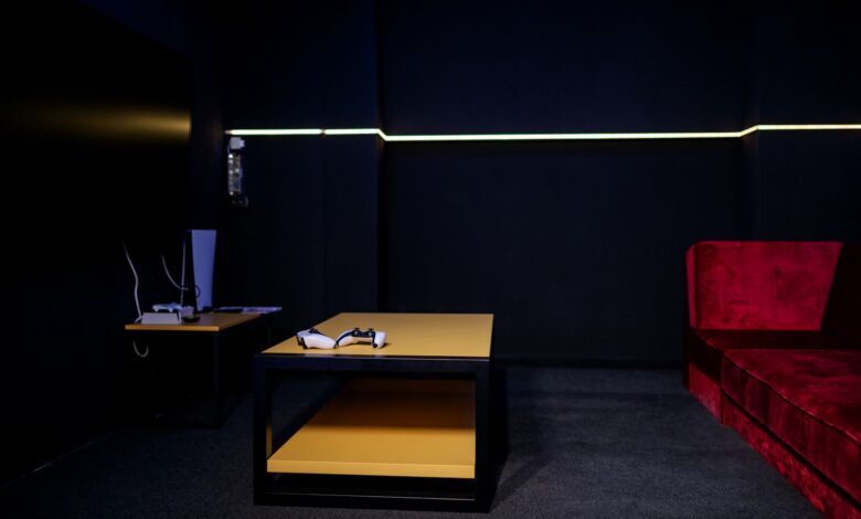 A sleek gaming room featuring controllers and vibrant furniture, ideal for entertainment enthusiasts.