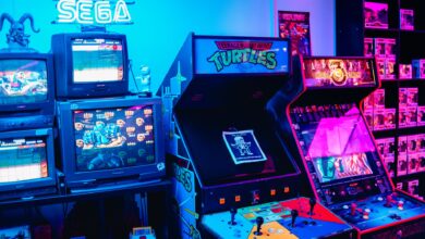A vibrant retro arcade room featuring classic gaming machines and colorful neon lighting.