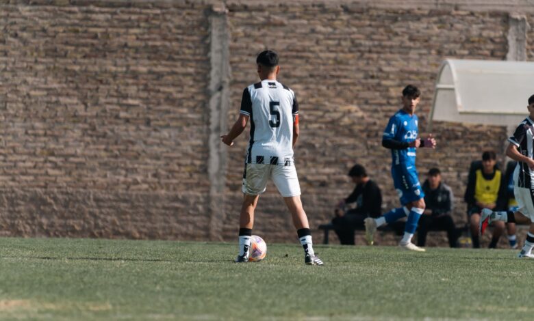Teenage soccer player in action on the field, wearing number 5 jersey outdoors.