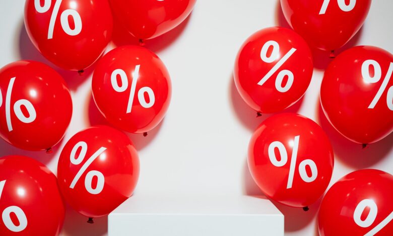 Red balloons with percentage signs, ideal for marketing promotions and sales events.