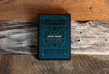 Blue Star Wars themed playing cards on a textured wooden surface.