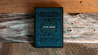 Blue Star Wars themed playing cards on a textured wooden surface.