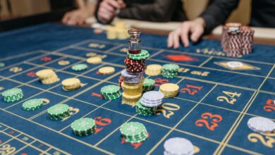 A casino table featuring stacked gaming chips and a roulette layout, suggesting gameplay.