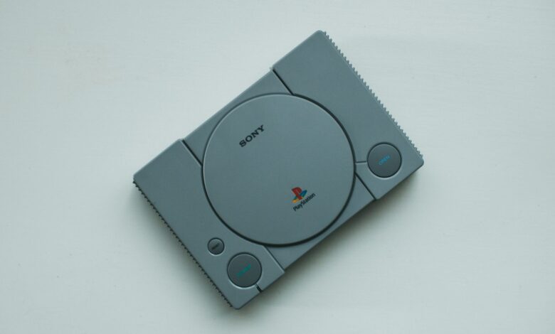 Close-up of a vintage Sony PlayStation console on a white background, highlighting retro gaming vibes.