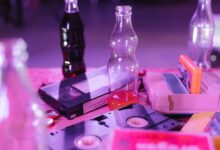 Vintage VHS tapes and colorful soda bottles on display, capturing nostalgia and retro aesthetics.