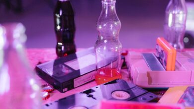 Vintage VHS tapes and colorful soda bottles on display, capturing nostalgia and retro aesthetics.