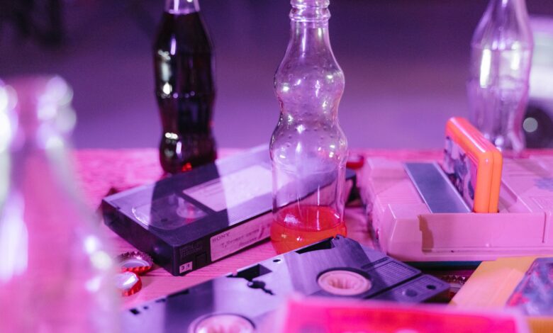 Vintage VHS tapes and colorful soda bottles on display, capturing nostalgia and retro aesthetics.