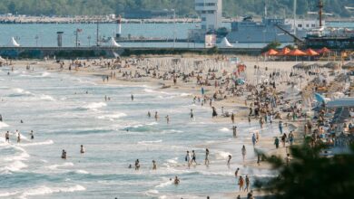 Crowded beach in Bulgaria with people enjoying a sunny day by the shore.