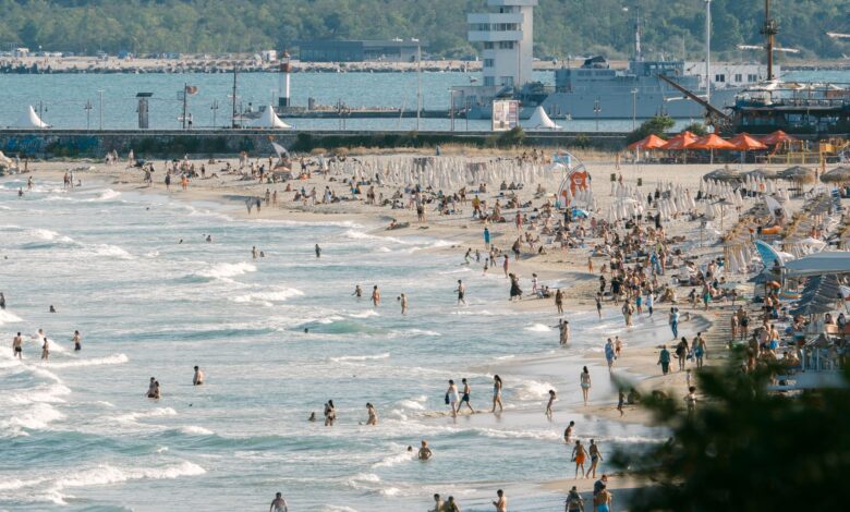 Crowded beach in Bulgaria with people enjoying a sunny day by the shore.
