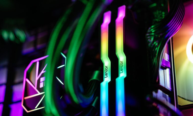 Close-up of colorful RGB illuminated PC components showcasing RAM and cooling system.