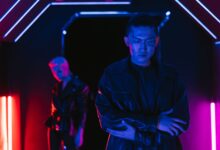 A cyberpunk-inspired scene with neon lights and characters in a futuristic setting.