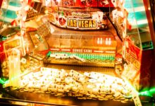 Colorful casino game machine featuring Las Vegas theme with coins and poker cards.