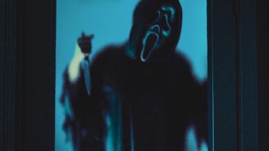 Eerie ghostface figure in blue lighting, ideal for Halloween themes.