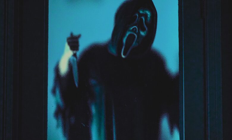 Eerie ghostface figure in blue lighting, ideal for Halloween themes.
