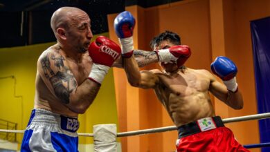 Two boxers engaged in a dynamic match, showcasing strength and strategy in the ring.