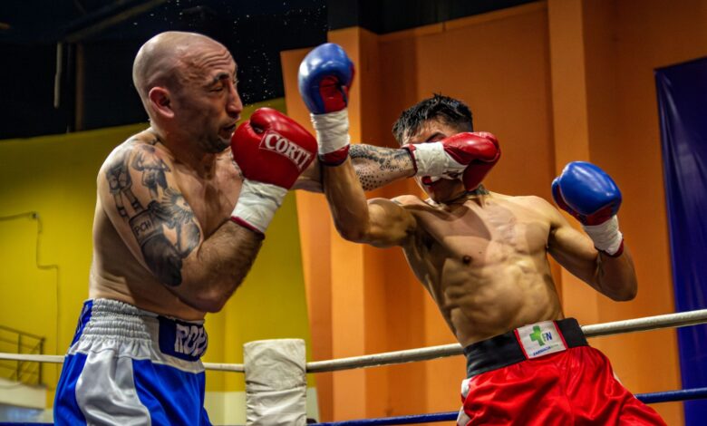 Two boxers engaged in a dynamic match, showcasing strength and strategy in the ring.