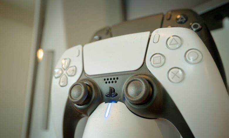 A detailed view of a gaming controller highlighting its buttons and LED light, perfect for gaming enthusiasts.