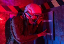 Female astronaut interacts with a control panel in a futuristic spaceship setting.