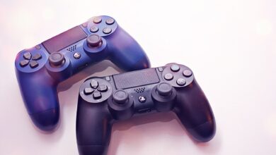 Close-up of two PlayStation controllers on a white surface, perfect for gaming themes.