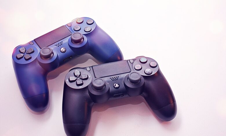 Close-up of two PlayStation controllers on a white surface, perfect for gaming themes.