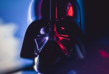 Close-up of a Darth Vader mask with striking lighting effects, showcasing cinematic appeal.