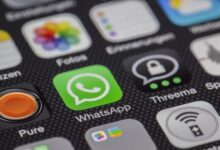 Detailed macro of smartphone screen showcasing popular app icons like WhatsApp.