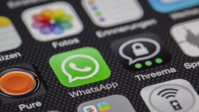 Detailed macro of smartphone screen showcasing popular app icons like WhatsApp.