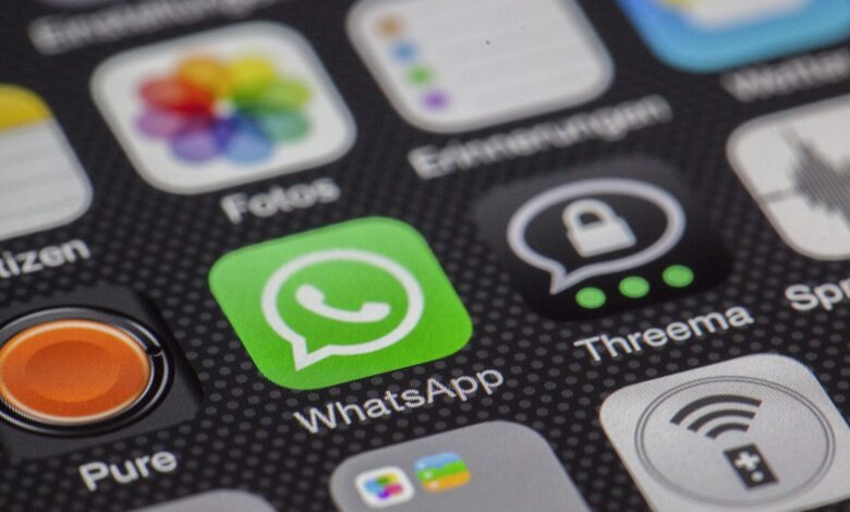 Detailed macro of smartphone screen showcasing popular app icons like WhatsApp.