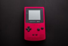 Close-up of a red Nintendo Game Boy Color on a dark backdrop, showcasing retro gaming nostalgia.