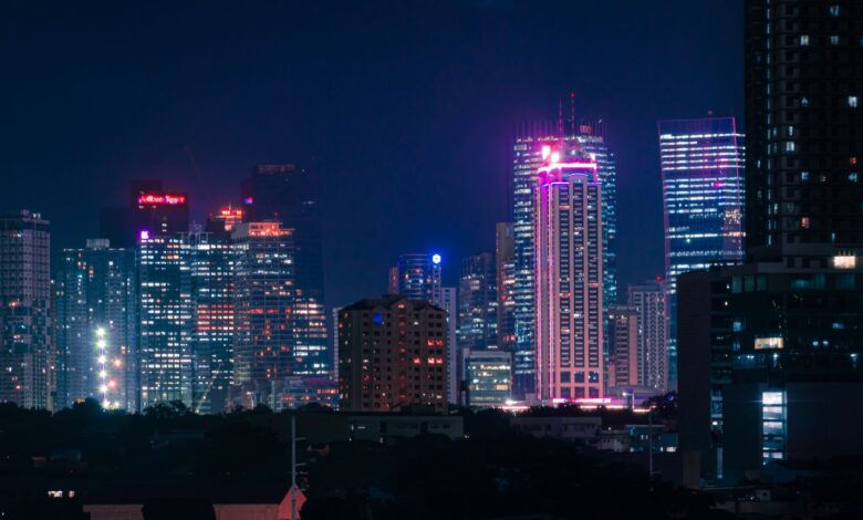 Dynamic cityscape with neon-lit skyscrapers at night, capturing urban energy and vibrant city life.