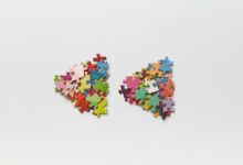 Brightly colored puzzle pieces arranged on a white surface, ideal for creative projects.