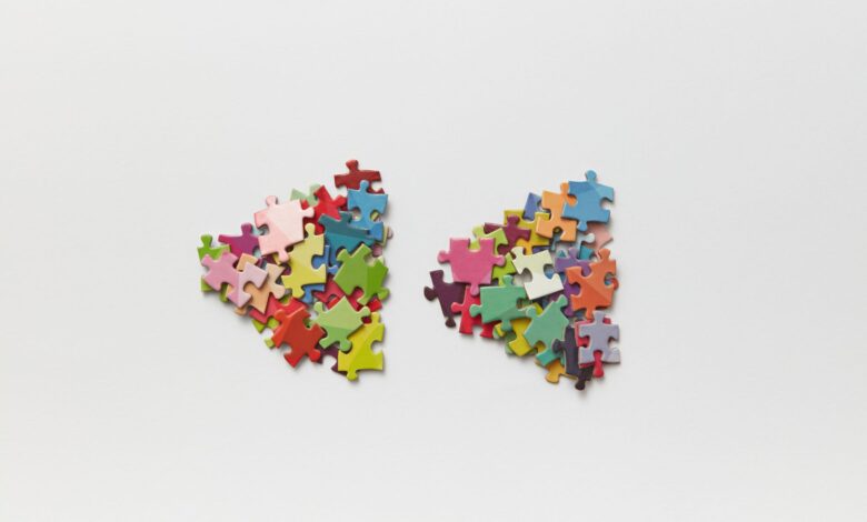 Brightly colored puzzle pieces arranged on a white surface, ideal for creative projects.
