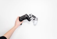 Black and white gaming controllers on a white background, emphasizing minimalism.