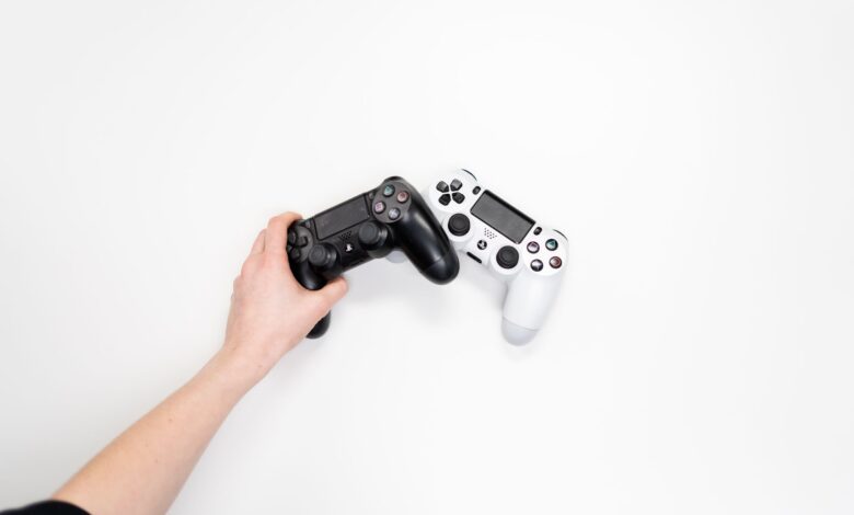 Black and white gaming controllers on a white background, emphasizing minimalism.
