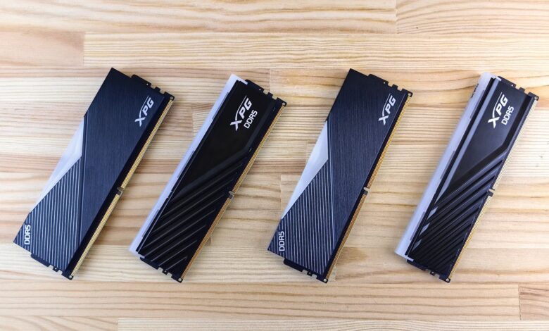 Four XPG DDR5 RAM modules aligned on a wooden surface, showcasing modern computing technology.