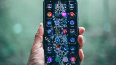 Crop anonymous person using mobile phone with various apps for social network and internet